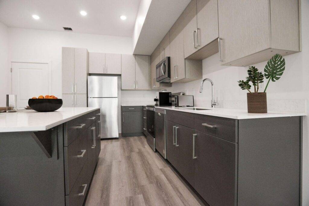 Kitchen interior showcasing stainless steel appliances alongside elegant gray cabinets