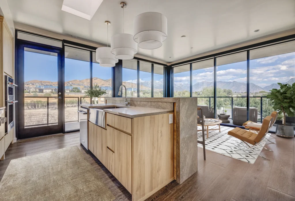 Contemporary kitchen design with a breathtaking mountain view framed by large windows, creating a serene atmosphere.