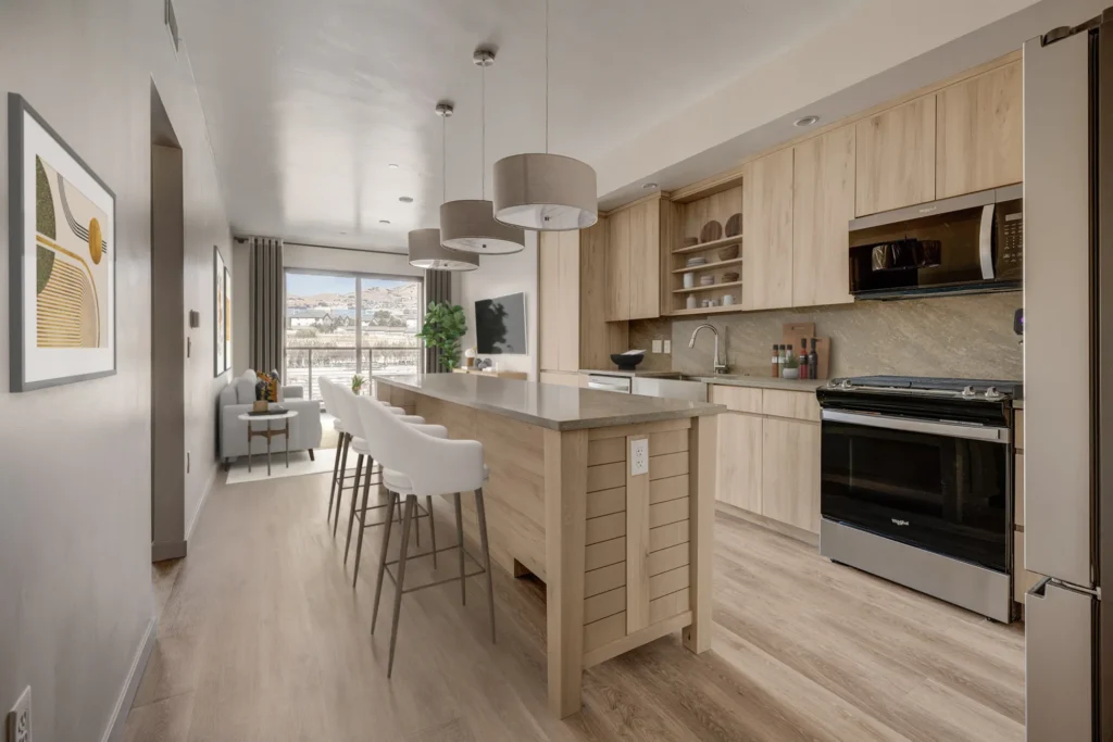 A modern kitchen featuring a bar and a dining area, designed for functionality and style by scs Multifamily.