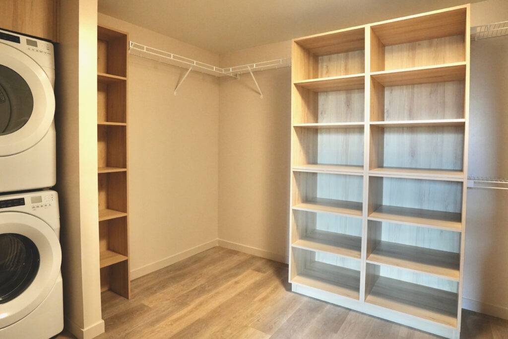A laundry room featuring a washer and dryer, designed for scs Multifamily properties.