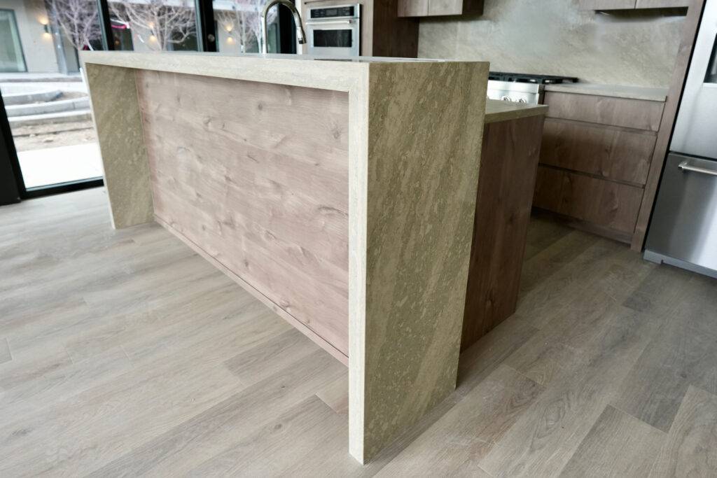 A modern kitchen featuring wooden cabinets and stainless steel appliances, designed by scs Multifamily.
