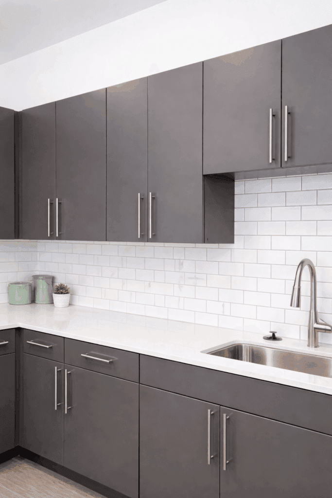 Modern kitchen with dark wood cabinets designed by SCS Multifamily